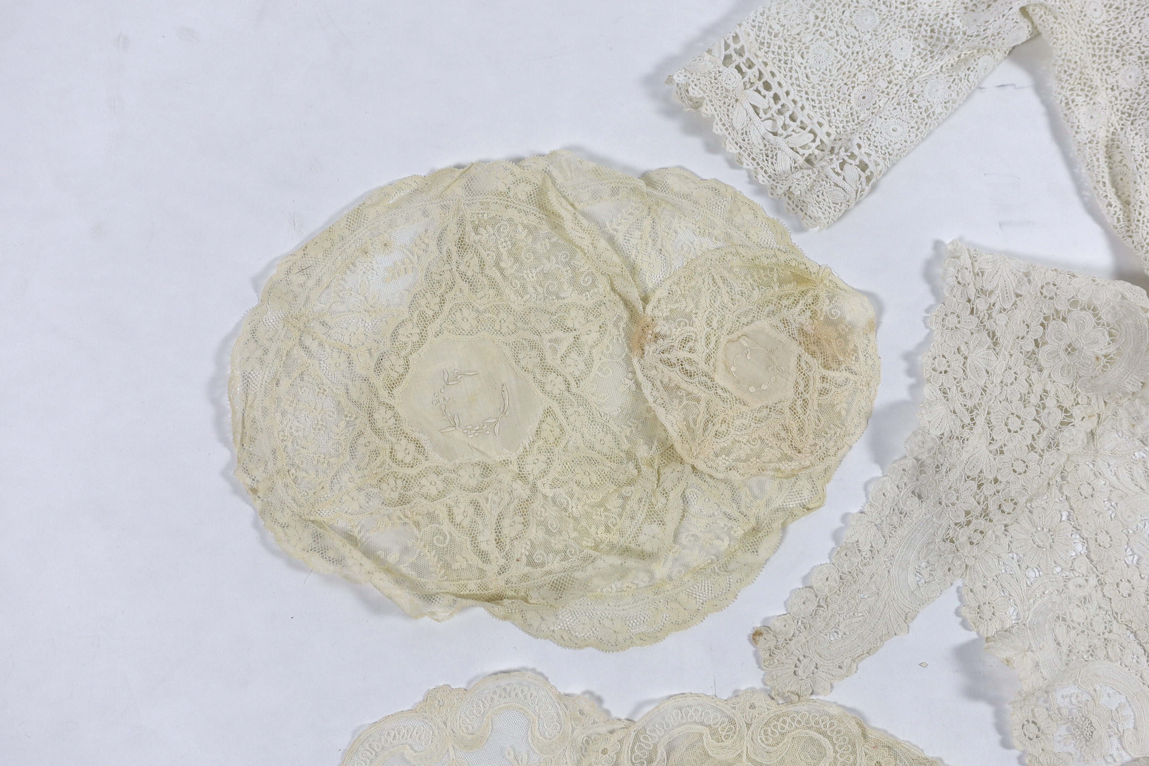 An Edwardian handmade Irish crocheted ladies blouse (small size), a Brussels hand bobbin lace Bertha with Point de Gaze insertions, two large and one small Normandy lace mats, four large and two smaller similar needle la